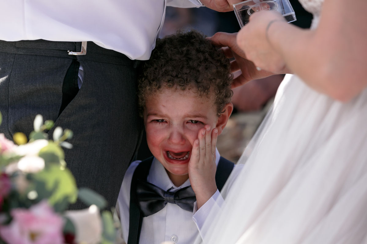 CryingRingBearerStandsWithParents