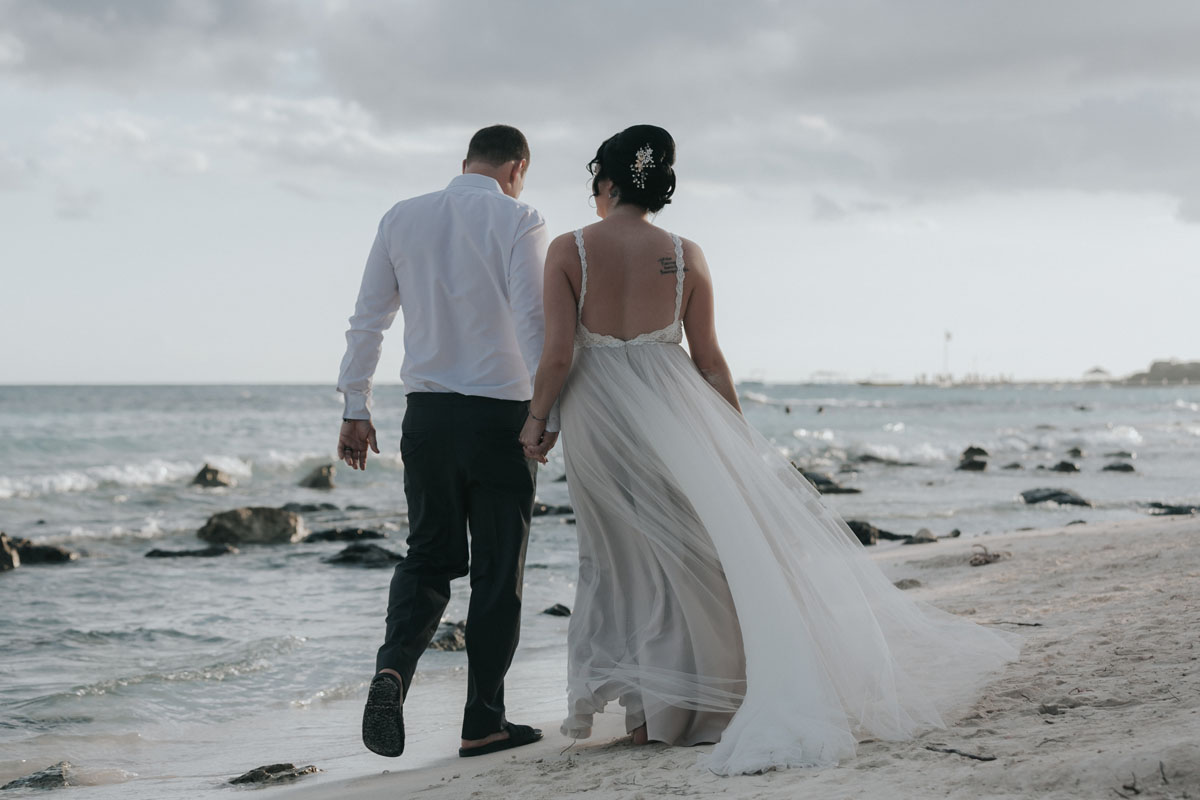 NewlywedsWalkOnBeach