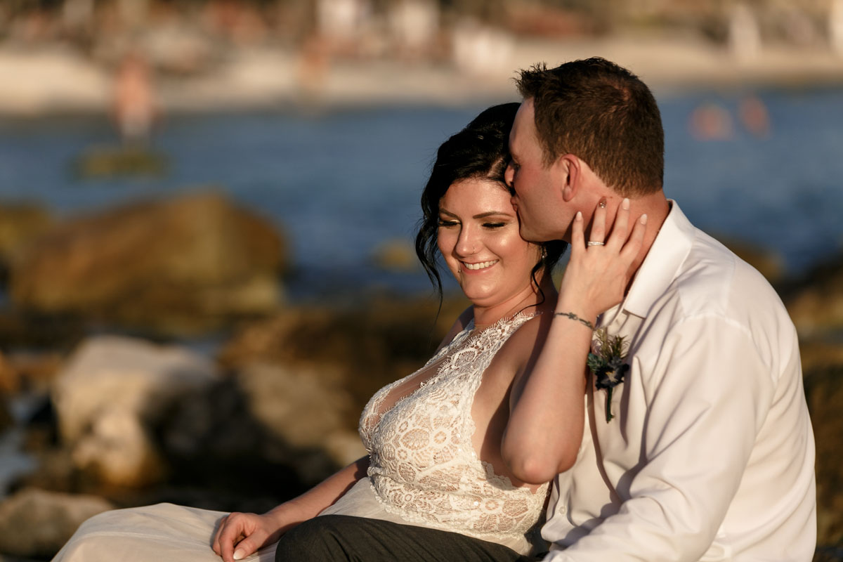 NewlywedsEmbraceAtSunset