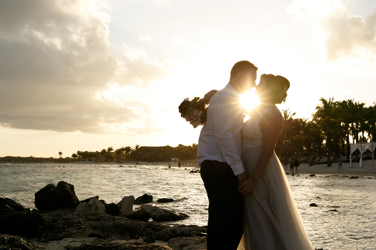 NewlywedsEmbraceAtSunset