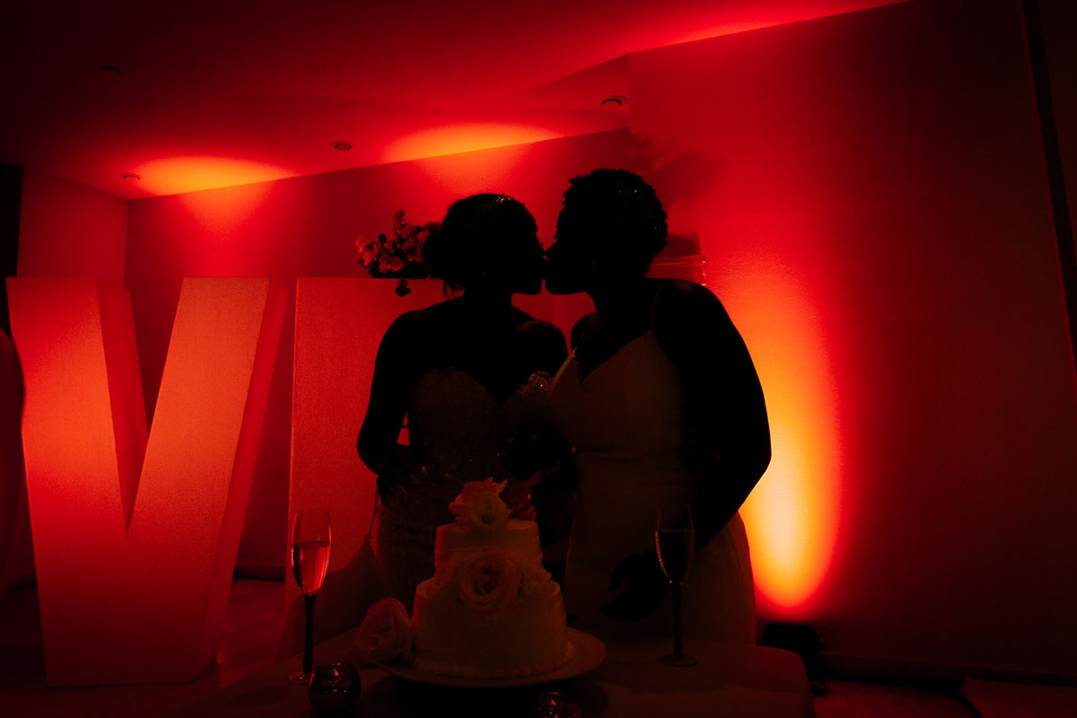 DreamsPlayaMujeresNewlywedsKissByLoveSign