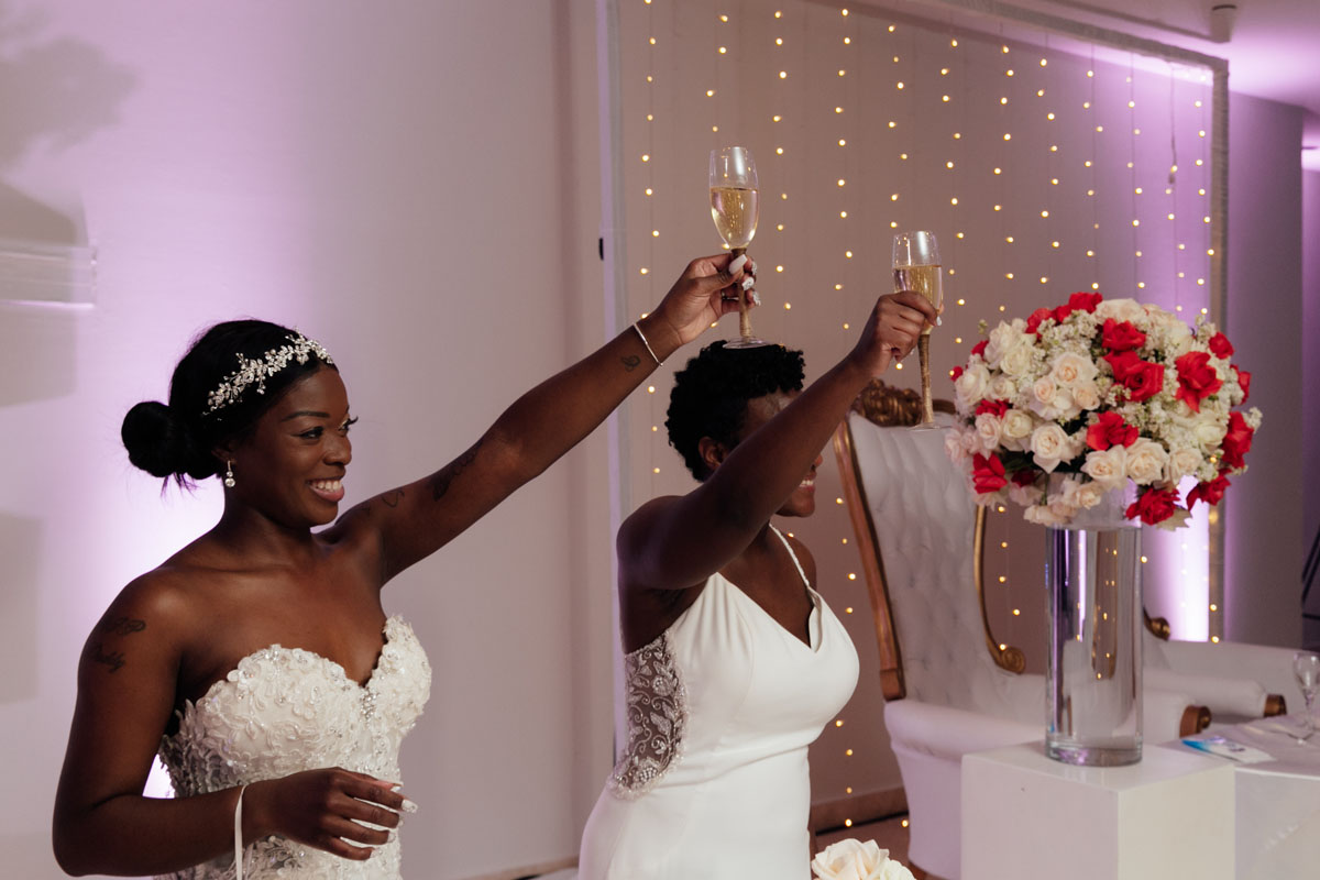 NewlywedsRaiseGlassesInChampagneToast