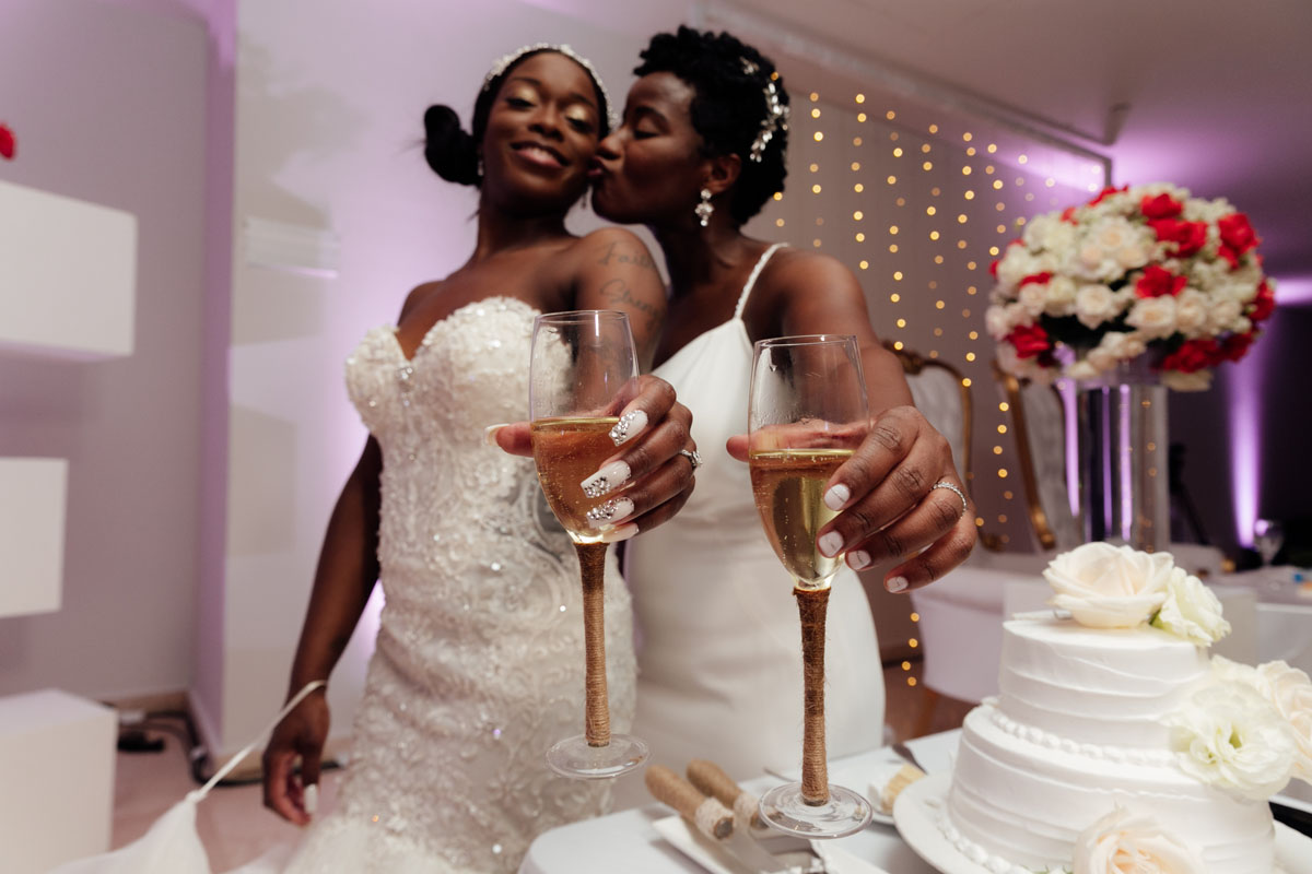 NewlywedsKissHoldingChampagneToast