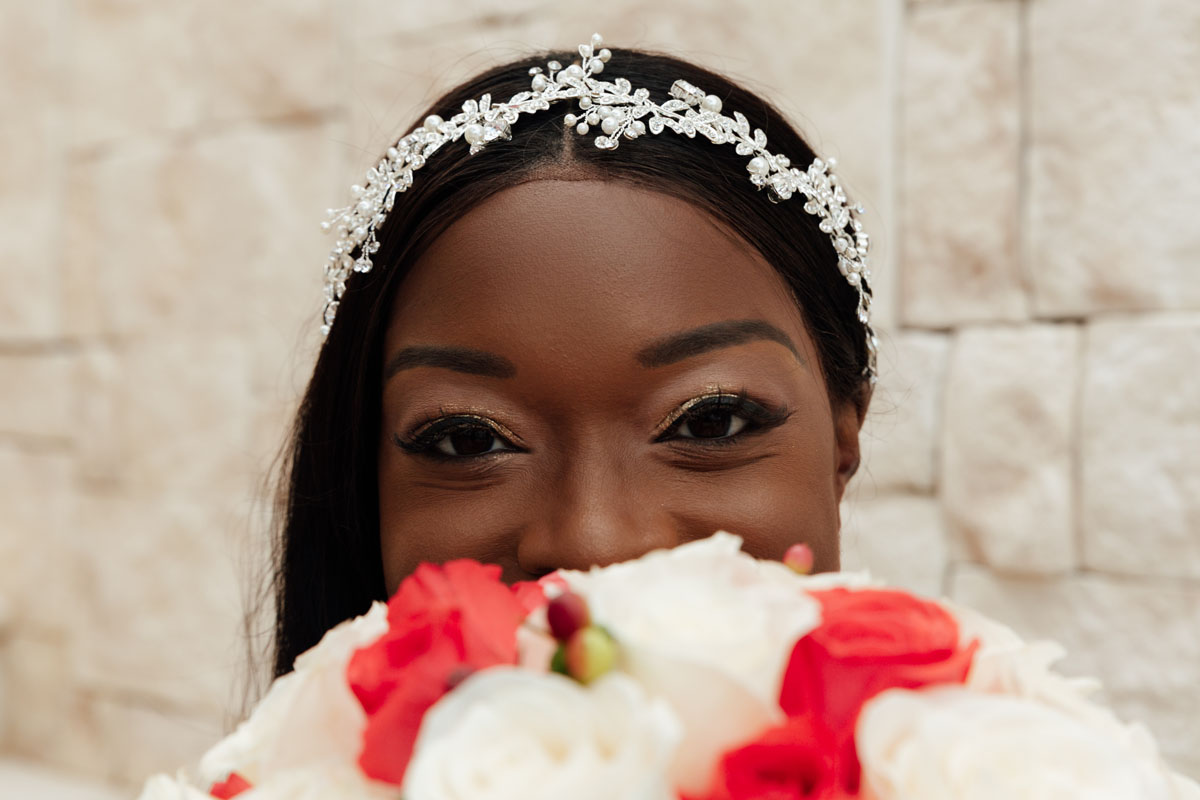 PlayaMujeresBrideLooksOverRoseBouquet