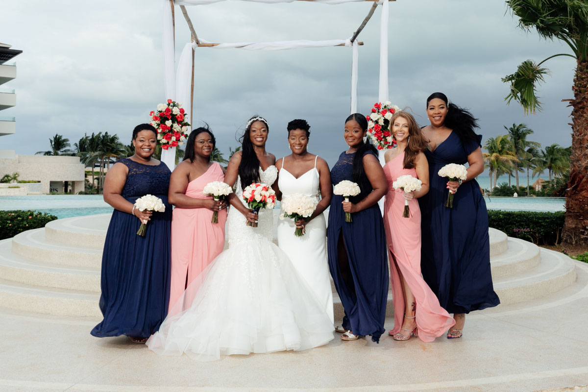 WeddingPartyAndNewlywedsPoseOnPodium