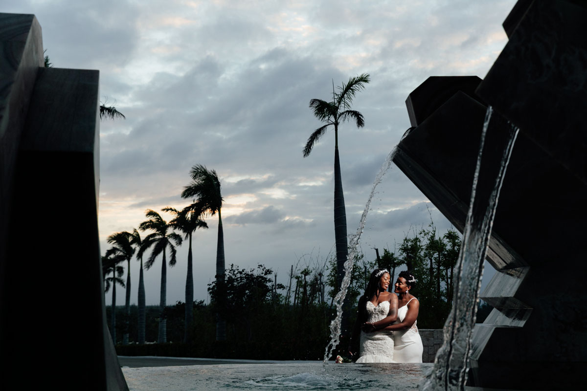 NewlywedsEmbraceByWaterFeature