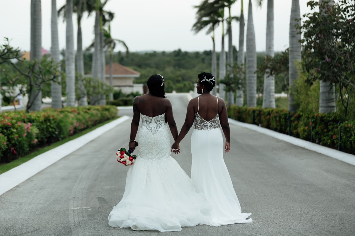 HappyNewlywedsStrollPathHoldingHands