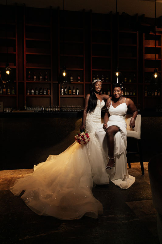 SmilingNewlywedsPoseInLounge