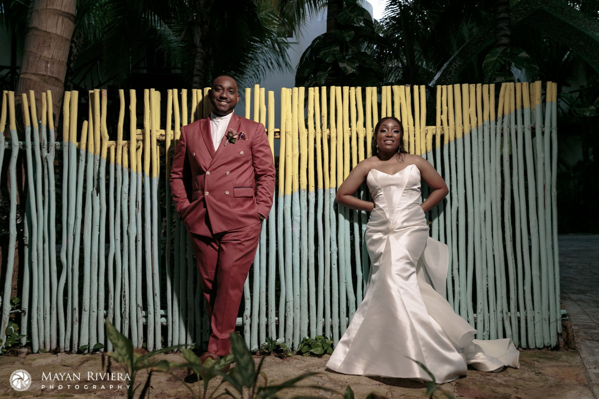 NewlywedsPoseByReedWall