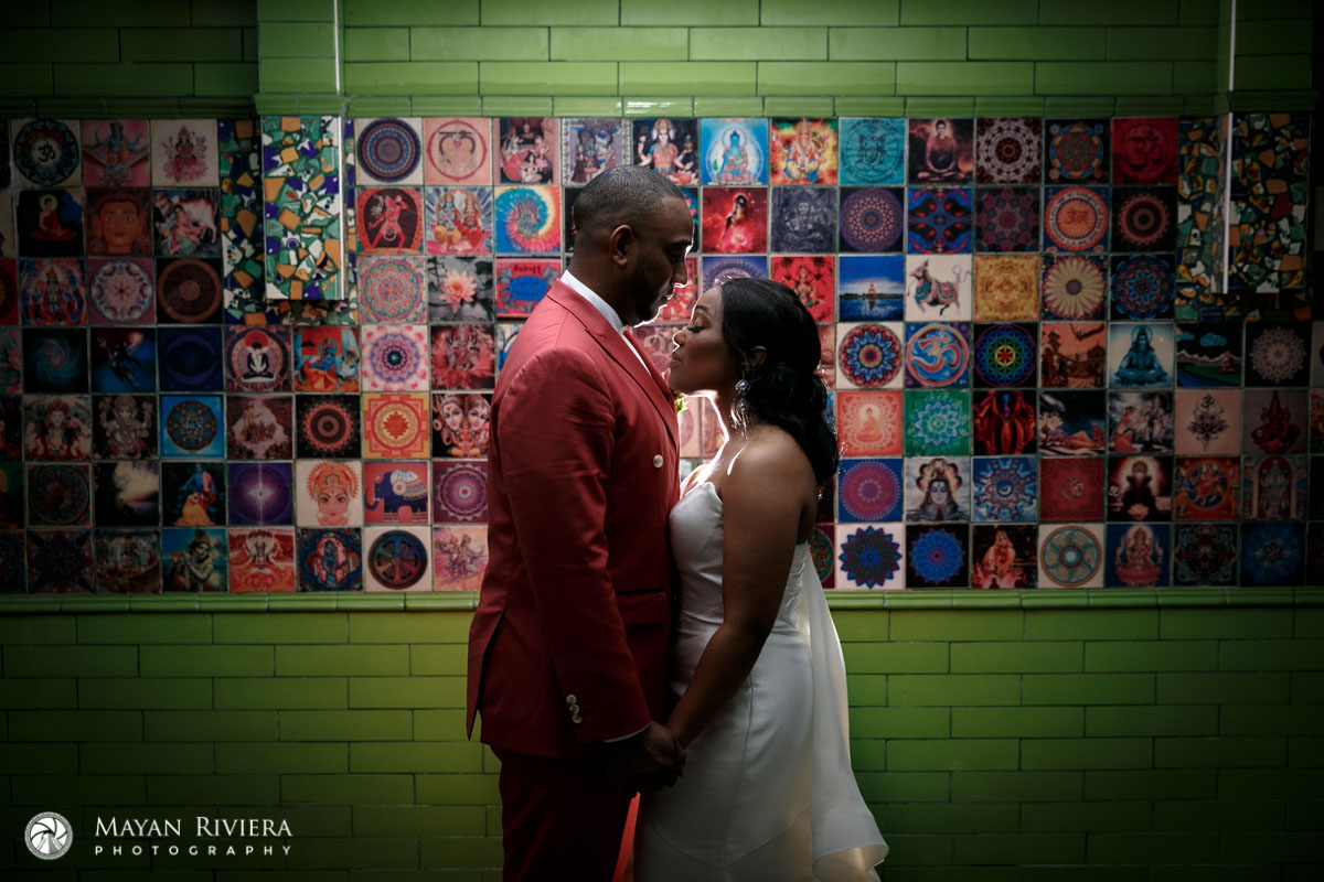 NewlywedsPoseByMosaicWall