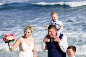 NewlywedsPoseWithSonsOnBeach