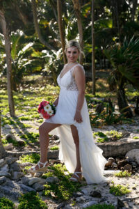 SmilingBridePosesStandingInJungle