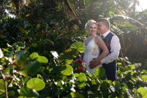 NewlywedsSmileEmbracingInJungle