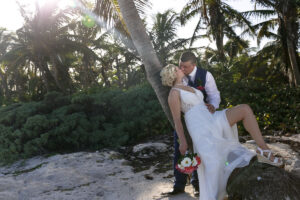 NewlywedsKissOnBeach