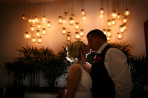 NewlywedsKissByGoldenLights