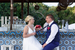 NewlywedsPosePlayfullyInBar