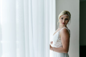 SmilingBridePosesByWindow