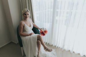 SmilingBridePosesByWindow