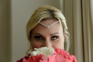 SmilingBrideLooksOverBouquet