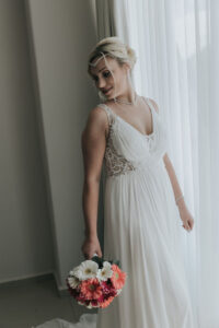 SmilingBridePosesByWindow