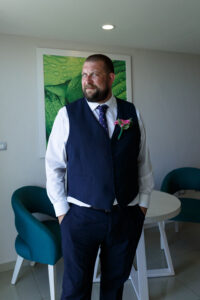 GrandSirenisGroomStandsInPose