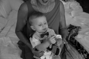 GrandmaHoldsBabyPlayingWithSandal