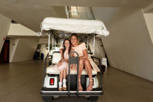 WeddingPartyRidesToCeremonyInGolfCart