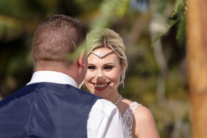 WeddingCoupleSmileAtEachOther