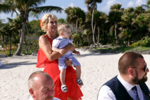 GrandmaWatchesCeremonyHoldingBaby