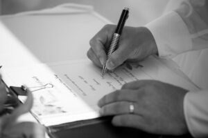 WeddingCoupleSignsMarriageCertificate