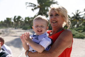 SmilingGrandmaHoldsClappingBaby