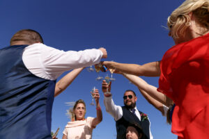 HoistingChampagneToToastNewlyweds