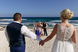 CheeringGuestsFramedByNewlywedsHoldingHands