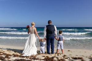 NewlywedsLookOutToSeaWithSons