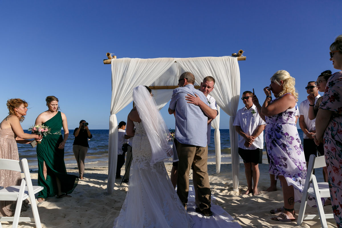 NowSapphireGroomHugsFatherInLaw