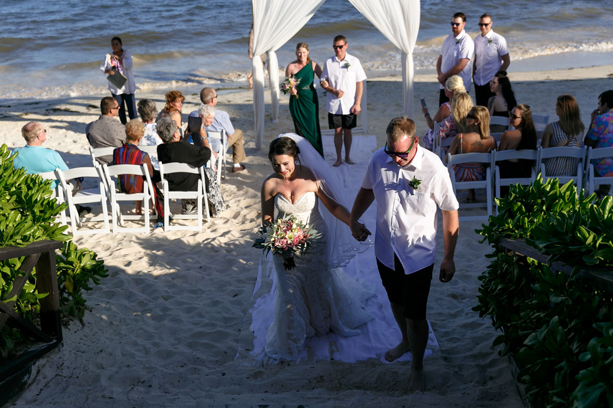 NowSapphireNewlywedsWalkOutHoldingHands