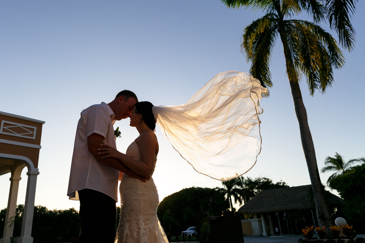 NowSapphireNewlywedsPoseWithFloatingVeil