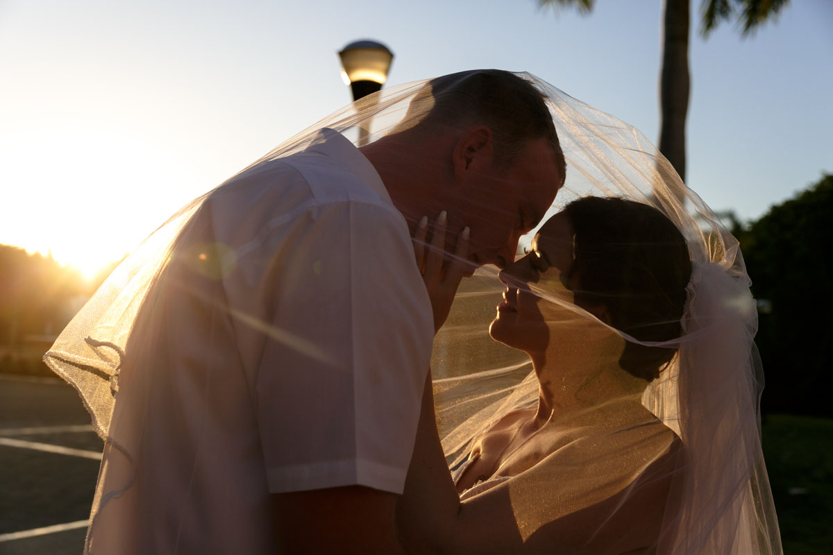 NowSapphireNewlywedsPoseUnderVeil