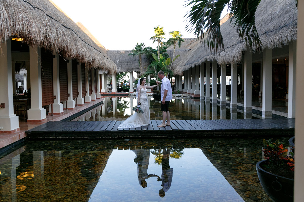 Newlyweds dance on pool bridge