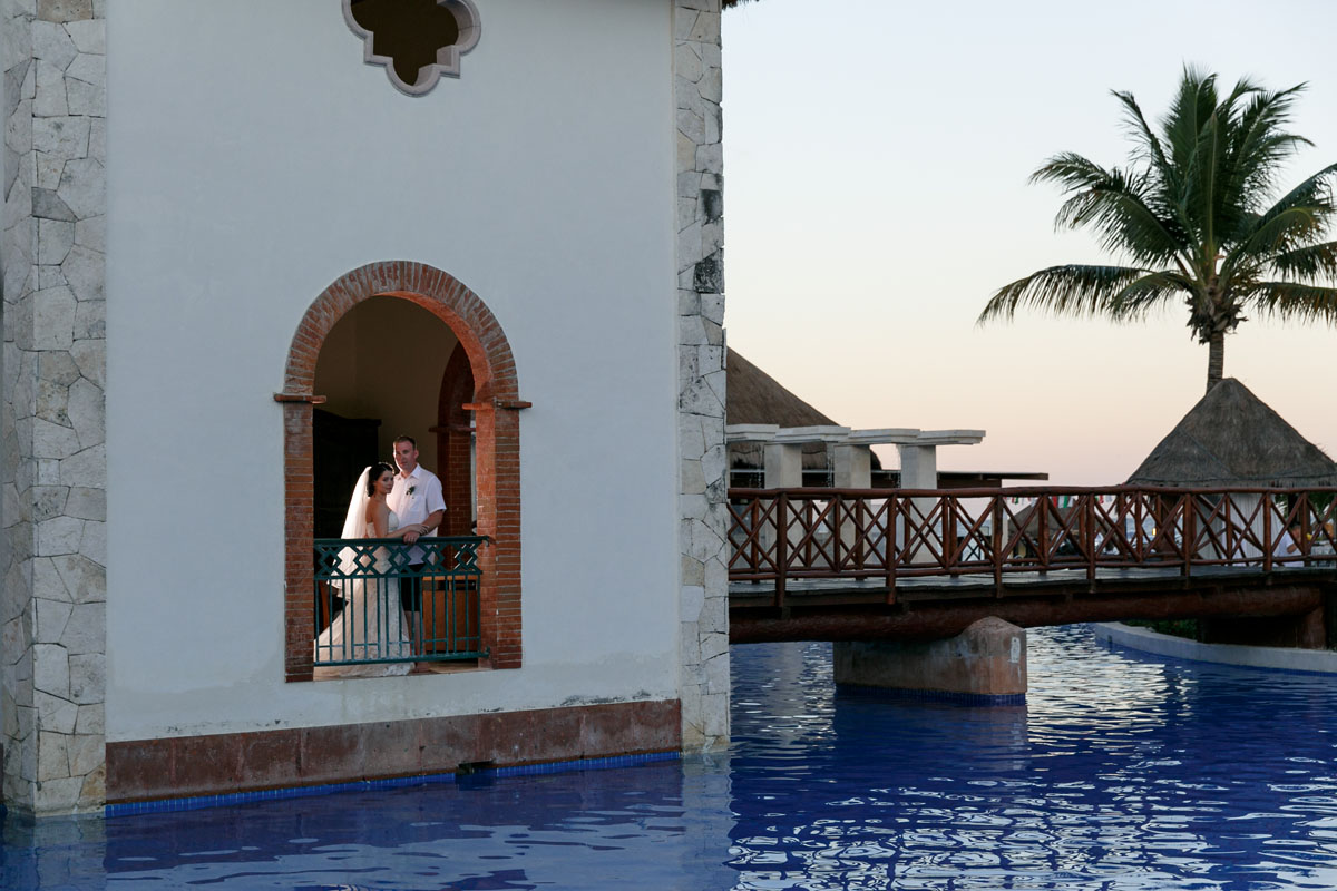 NewlywedsPoseInStoneArchway