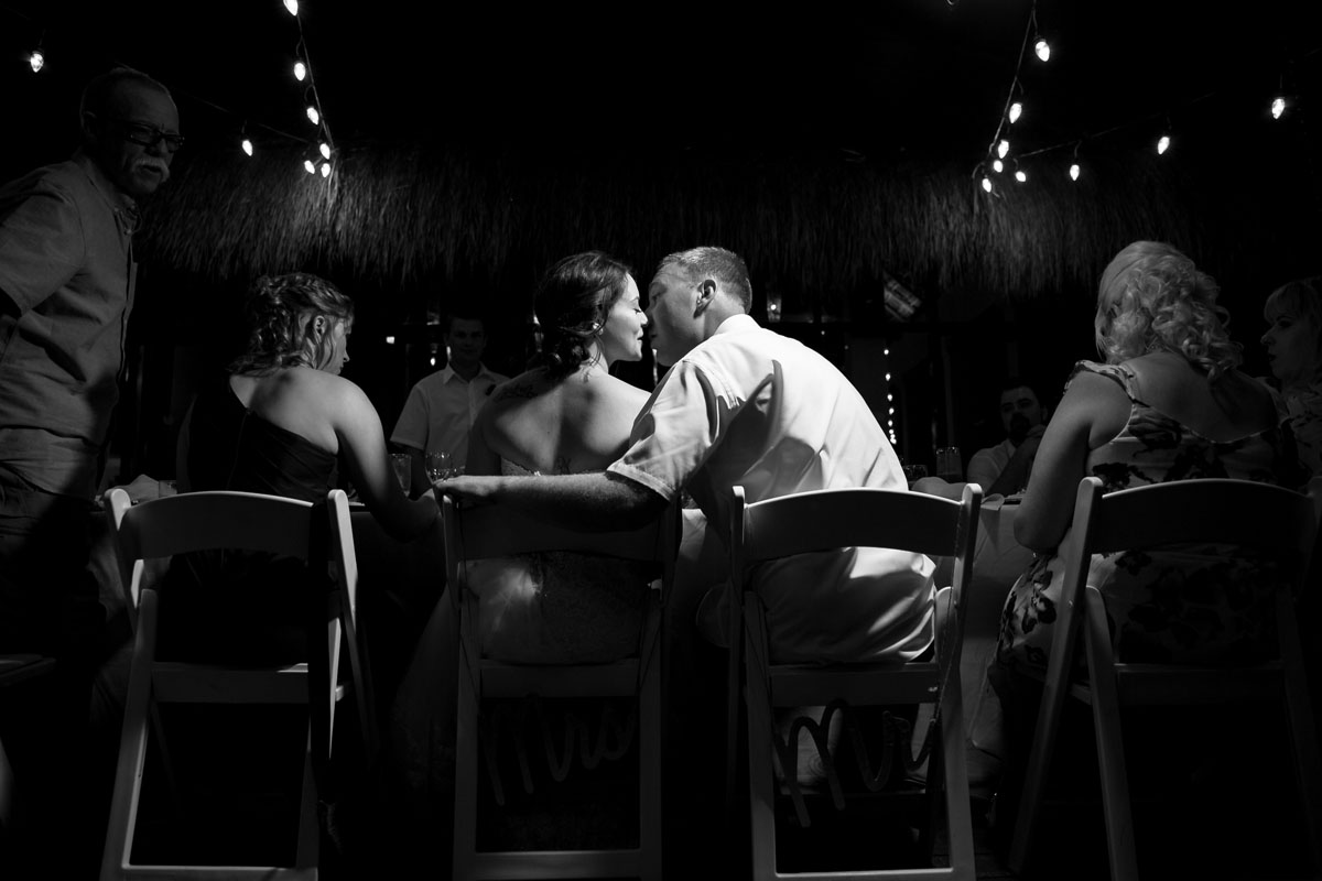 NewlywedsKissAtTable