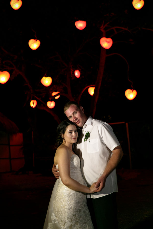 NewlywedsEmbraceUnderHeartLights