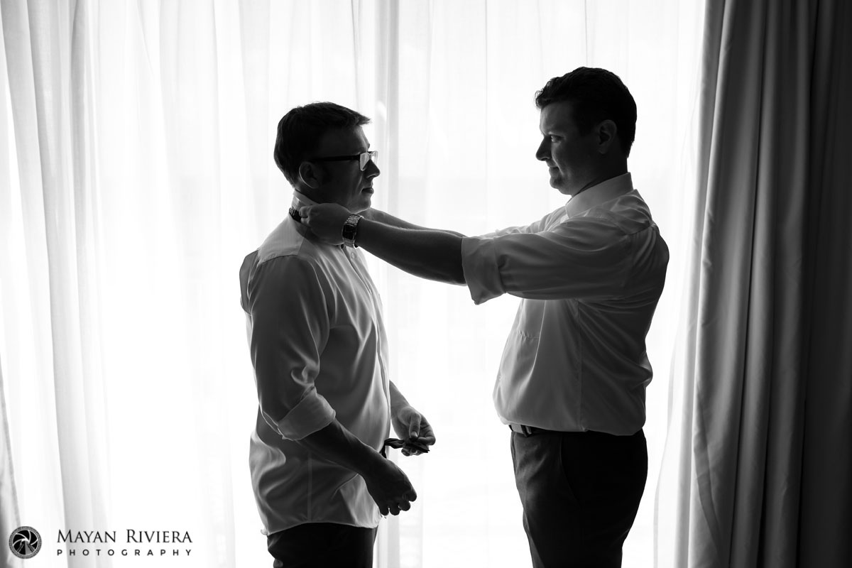 ORPGroomAndrewByWindowPuttingOnTie