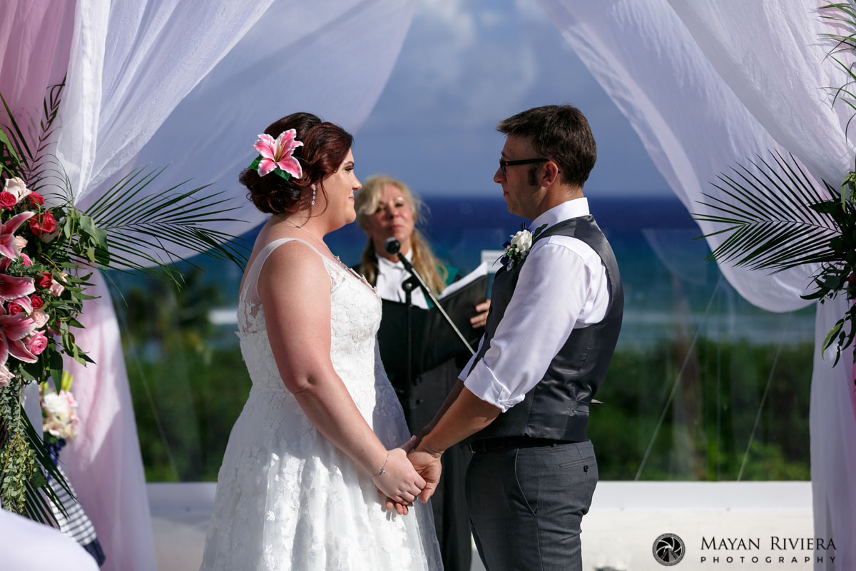 WeddingCoupleHoldHandsAtCeremony