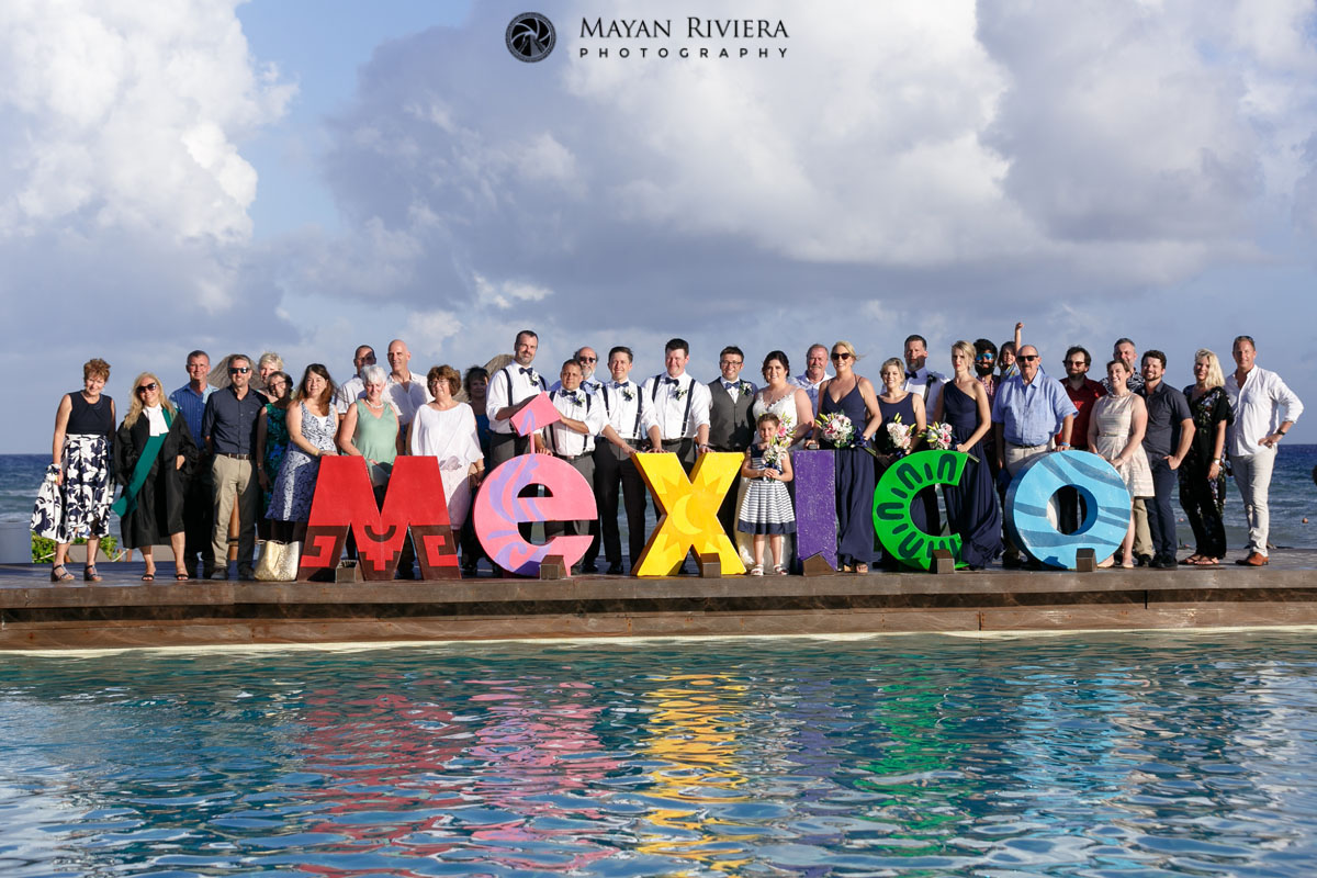 WeddingPartyAndGuestsBehindMexicoSign