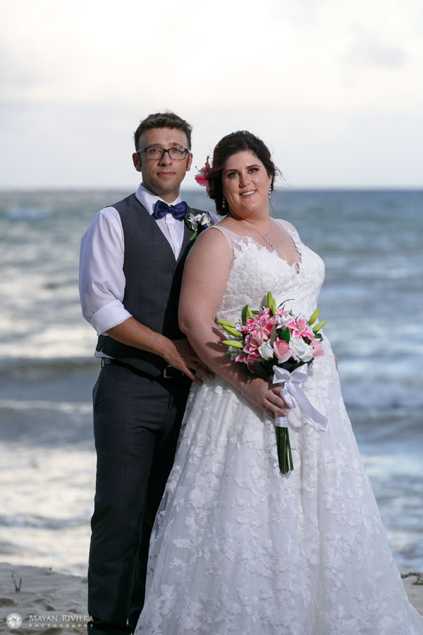 NewlywedsEmbraceOnBeach