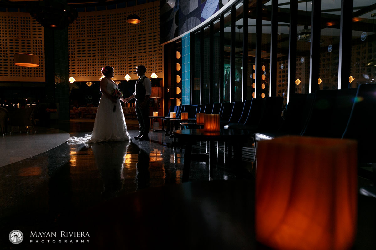 NewlywedsPoseInLoungeHoldingHands