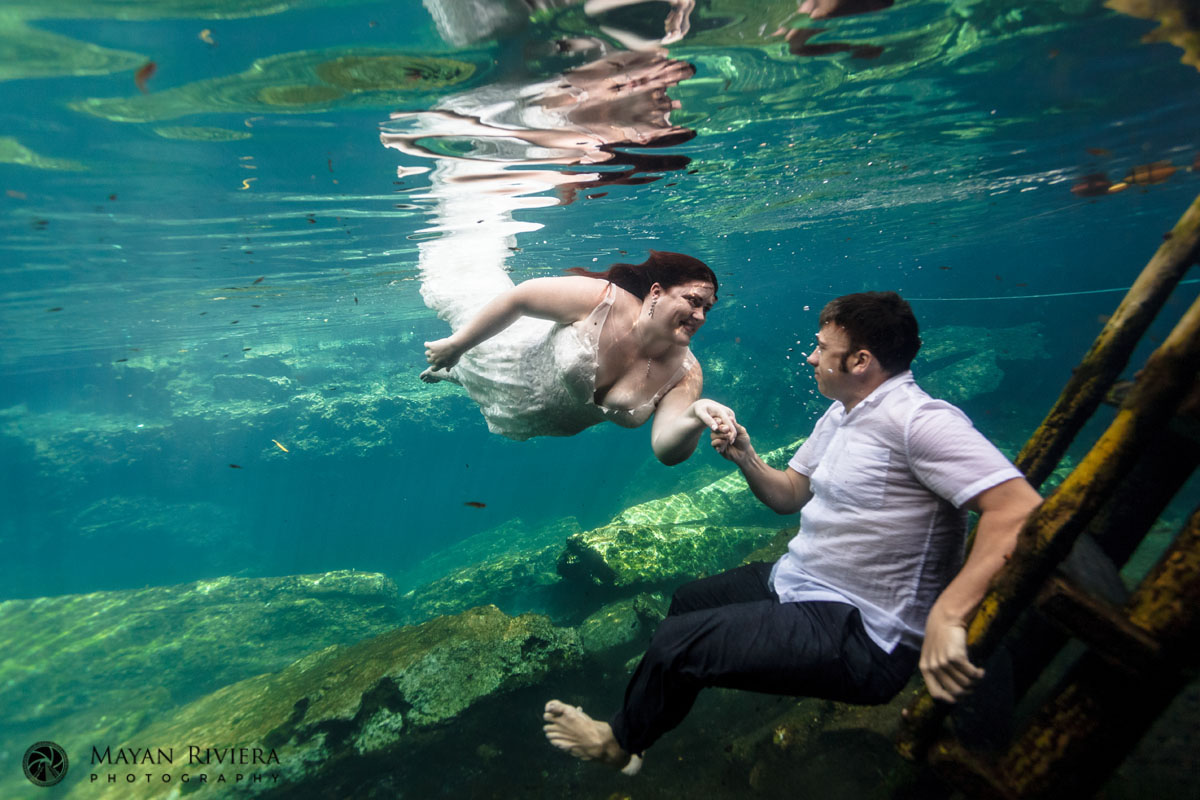 NewlywedsFloatUnderwaterInCenote