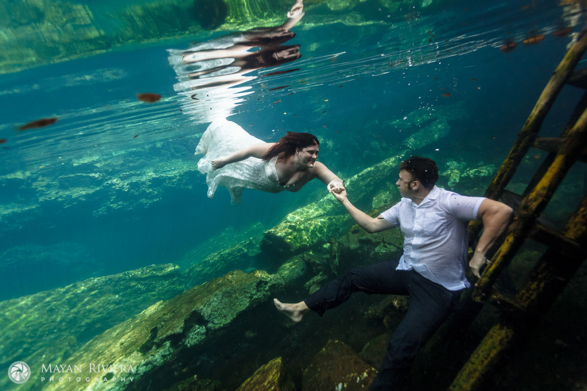 NewlywedsFloatUnderwaterInCenote