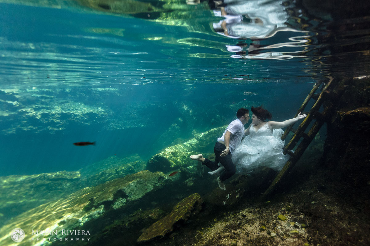NewlywedsFloatUnderwaterInCenote